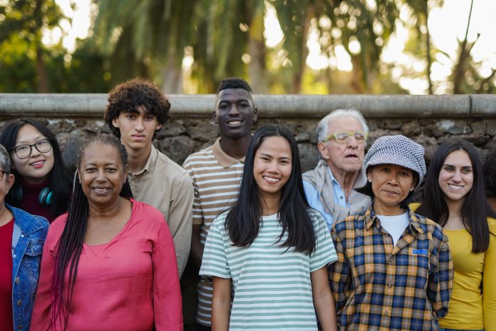 Group of multiracial people having fun together at city park - S