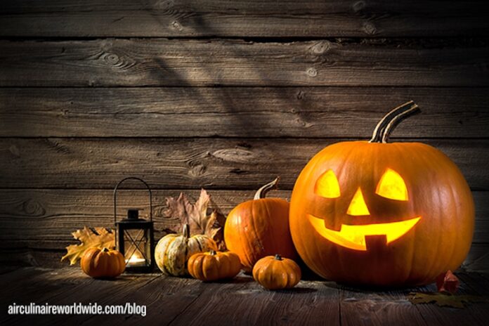 Halloween pumpkin head jack lantern on wooden background
